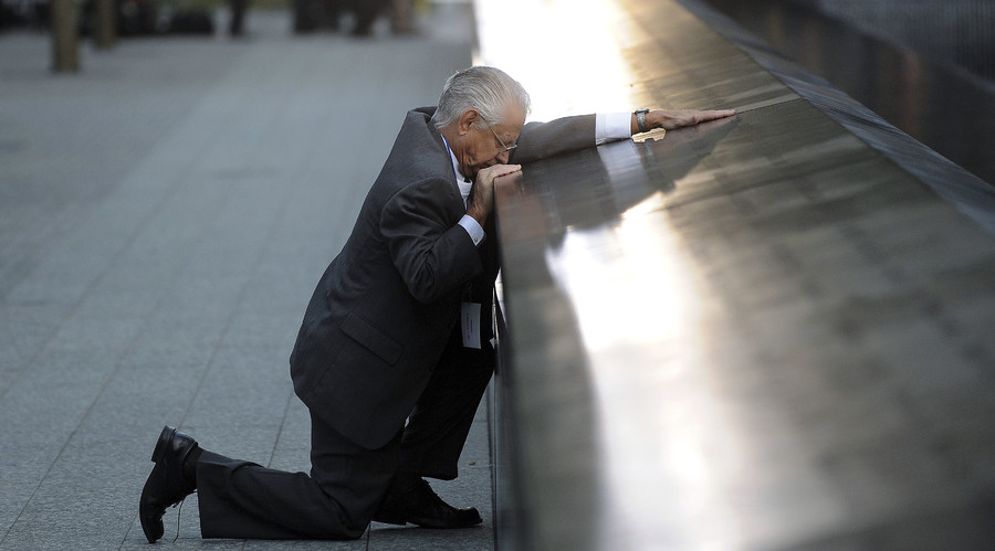 Robert Peraza who lost his son Robert David Peraza pauses at his son's name at the North Pool of the 9/11 Memorial during tenth anniversary ceremonies at the site of the World Trade Center in New York