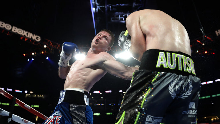 Saul 'Canelo&#039 Alvarez rocks Liam Smith with a body shot during Saturday's WBO world title showdown in Arlington Texas