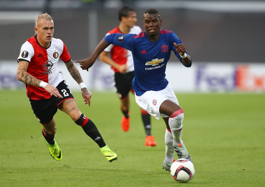 ROTTERDAM NETHERLANDS- SEPTEMBER 15 Rick Karsdorp of Feyenoord chases down Paul Pogba of Manchester United during the UEFA Europa League Group A match between Feyenoord and Manchester United FC at Feijenoord Stadion