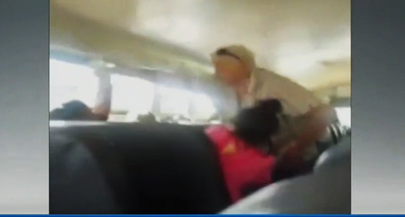 Bus driver Mary Black pouring water on student