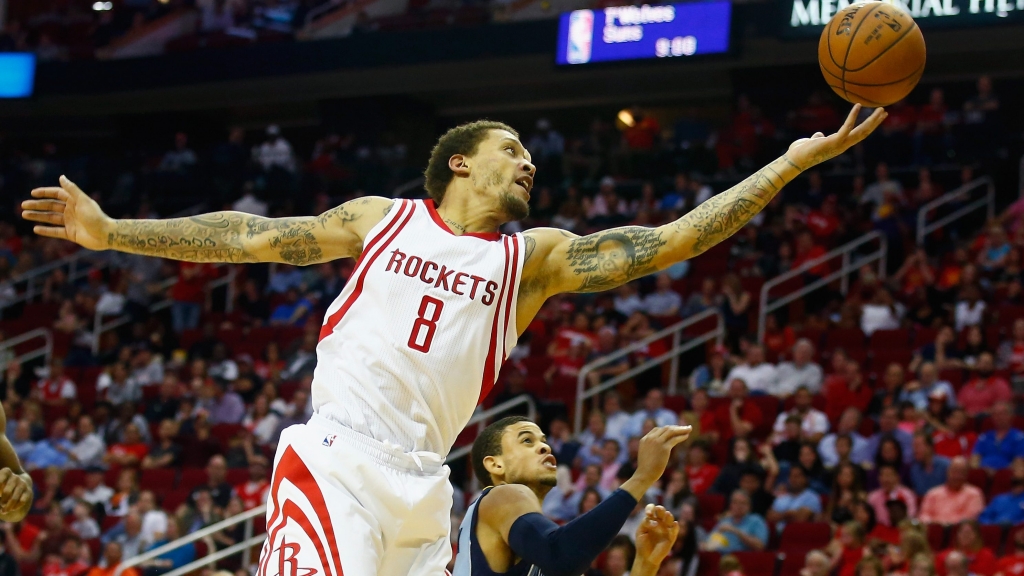 HOUSTON TX- MARCH 14 Michael Beasley #8 of the Houston Rockets drives with the basketball against Ray Mc Callum #5 of the Memphis Grizzlies during their game at the Toyota Center