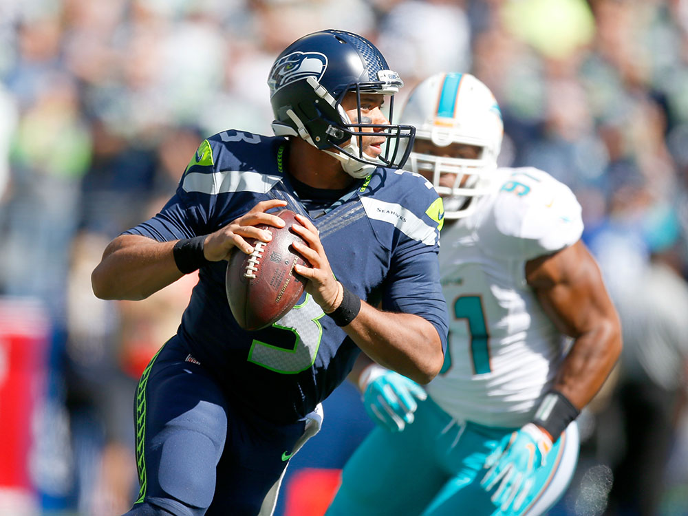 SEATTLE WA- Seahawks quarterback Russell Wilson looks to pass against the Miami Dolphins on Sunday at Century Link Field