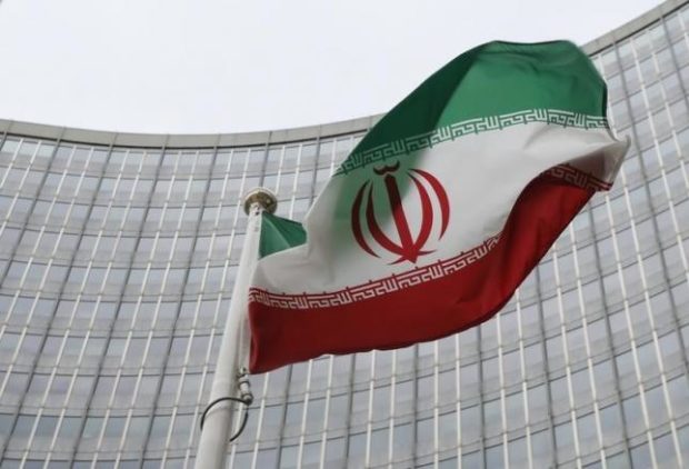 An Iranian flag flutters in front of the International Atomic Energy Agency headquarters in Vienna Austria