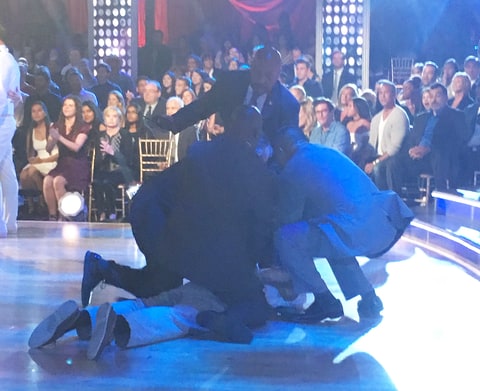 Security guards tackle the man who ran on stage.     Courtesy of Ingrid Meilan