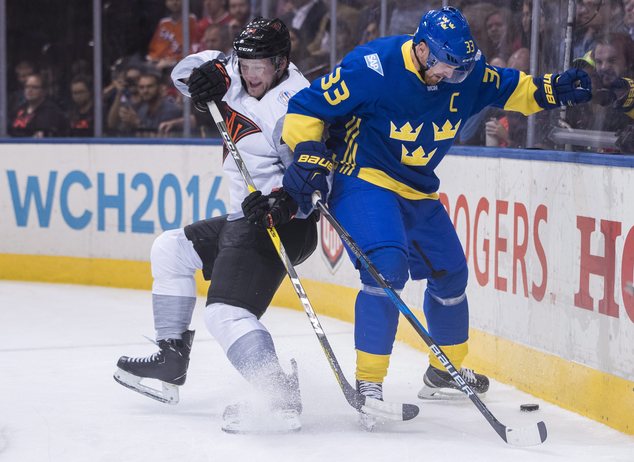 North America's Morgan Rielly left battles for the puck with Sweden's Henrik Sedin during the second period of a World Cup of Hockey game in Toronto Wedne