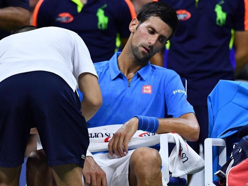 Serbian Novak Djokovic receives treatment during the game