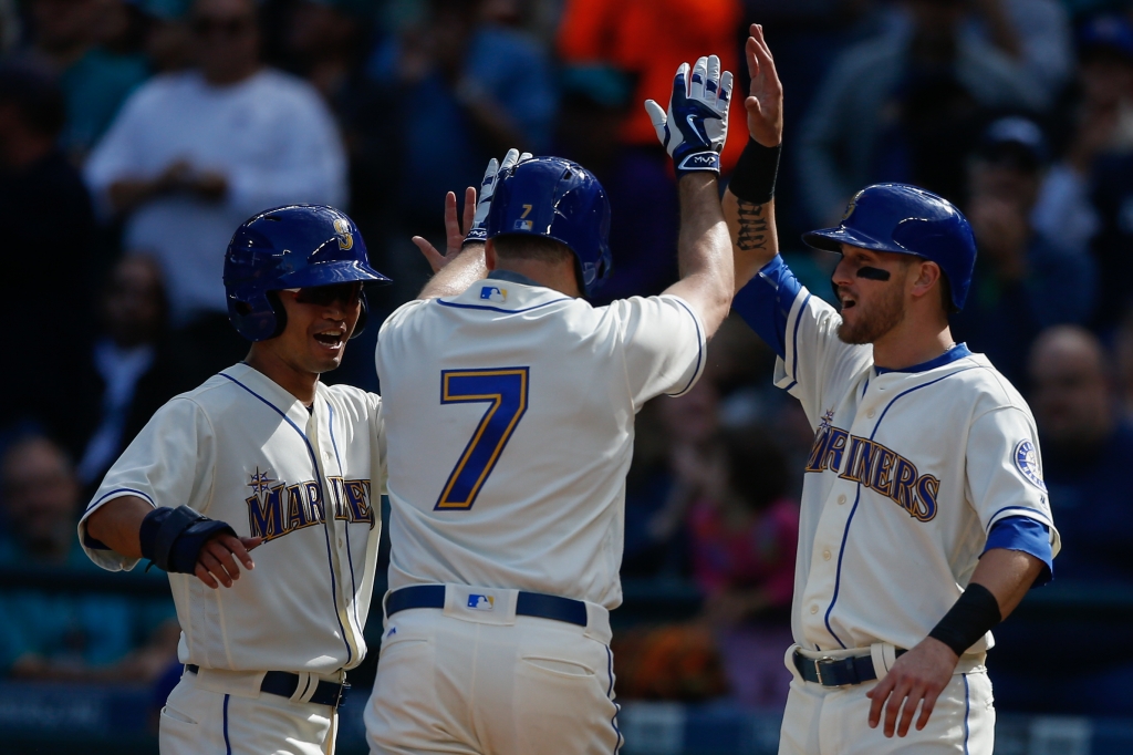 Seth Smith #7 of the Seattle Mariners is congratulated by Norichika Aoki #8 and Shawn O'Malley #36 after hitting a three-run homer in the fourth inning against the Houston Astros at Safeco Field