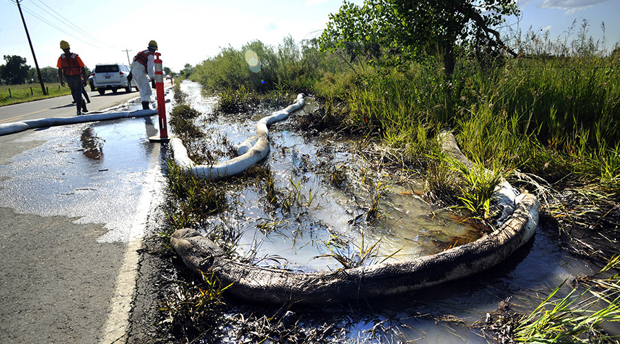 An emergency response crew hired by Exxon Mobil clean up an oil spill with an absorbent boom along the Yellowstone River in Laurel Montana