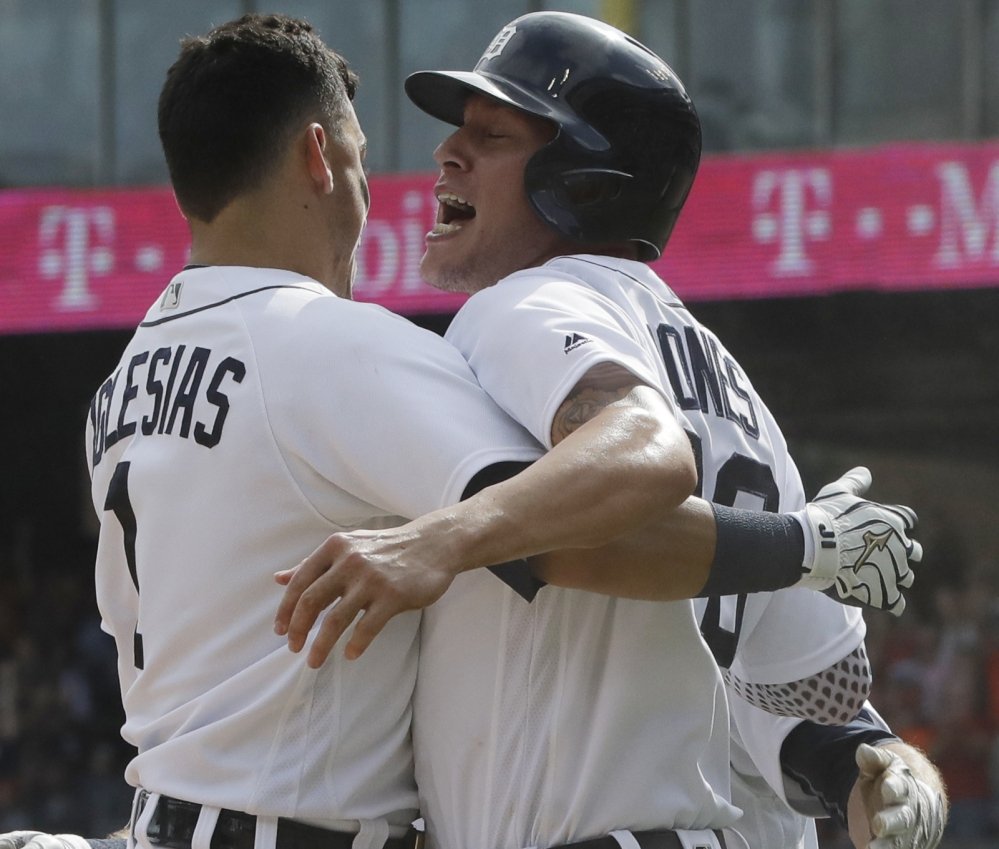 Detroit's Ja Coby Jones right is greeted by teammate Jose Iglesias after scoring the winning run in a 3-2 victory over the White Sox at Chicago on Wednesday