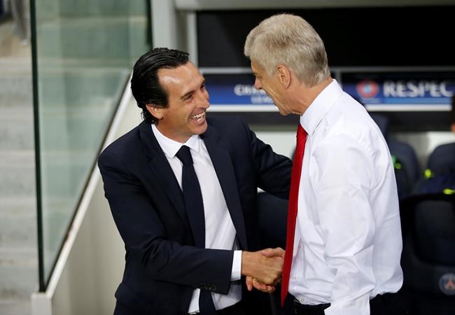 PSG head coach Unai Emery left greets Arsenal manager Arsene Wenger prior to the Champions League group A soccer match group between Paris Saint Germain and Arsenal at the Parc des Princes stadium in Paris Tuesday Sept. 13 2016. (AP