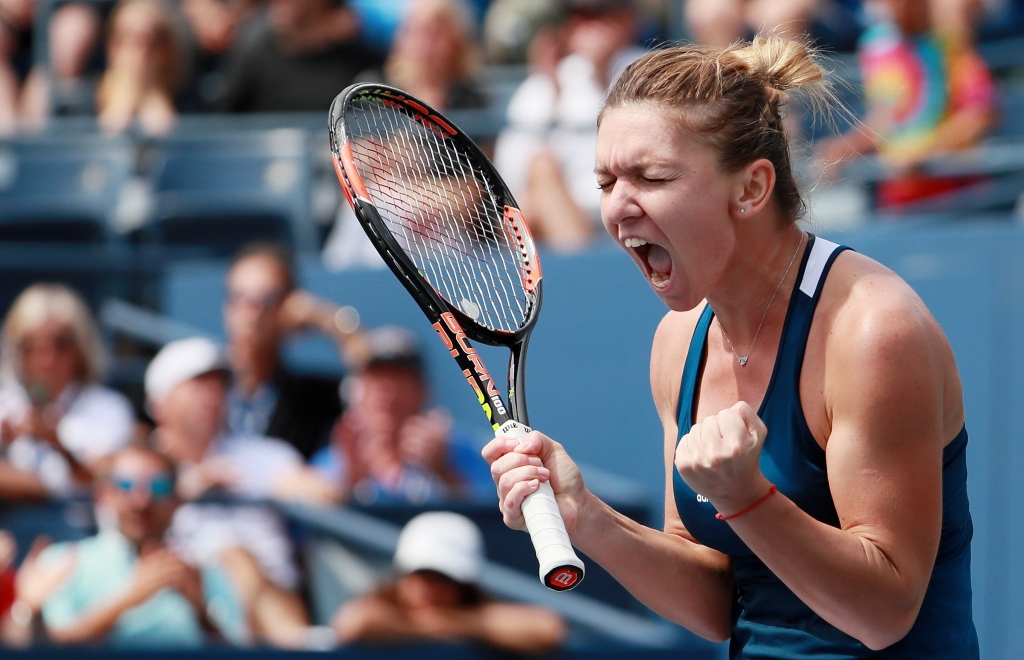 Simona Halep of Romania reacts after defeating Carla Suarez Navarro of Spain in New York City Monday. — AFP