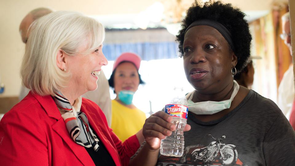 Sister Neill F. Marriott speaks with a volunteer