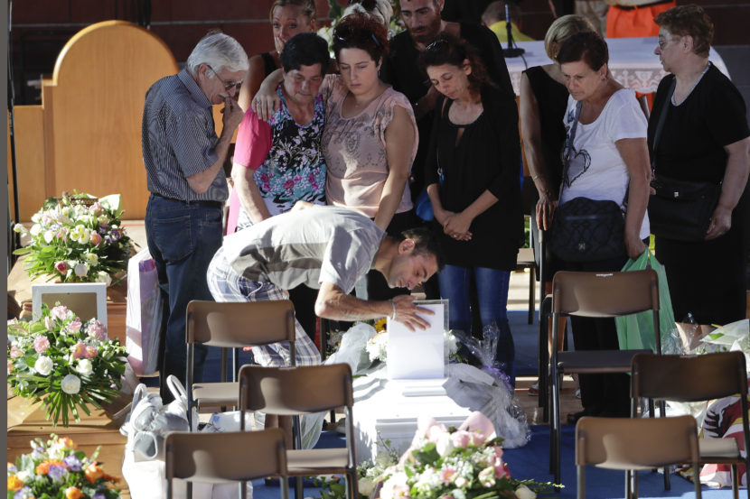 Relatives mourn over a coffin of one of the earthquake victims prior to the start of the funeral service on Saturday in Ascoli Piceno Italy. Gregorio Borgia  AP