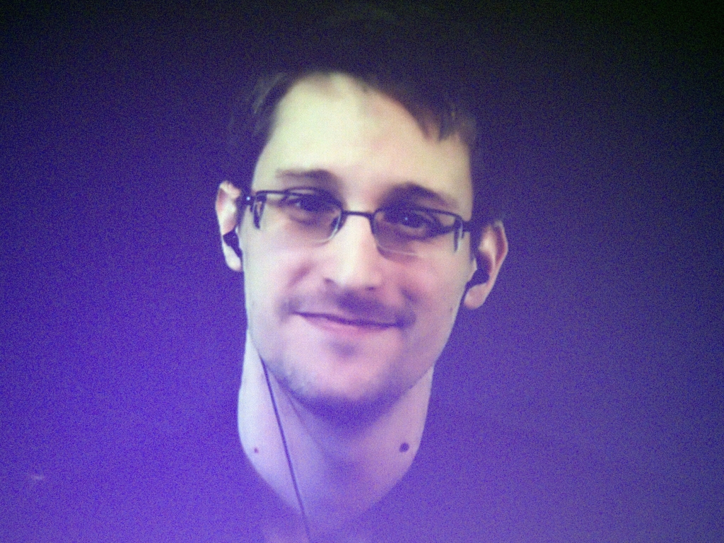 Edward Snowden who is in Moscow is seen on a giant screen during a live video conference for an interview as part of Amnesty International event in Paris in December 2014. The House Permanent Select Committee on Intelligence published a summary report