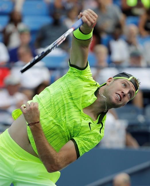 Jack Sock of the United States serves to Mischa Zverev of Germany at the U.S. Open tennis tournament Wednesday Aug. 31 2016 in New York