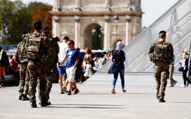 Soldiers patrol around the Louvre Museum in Paris