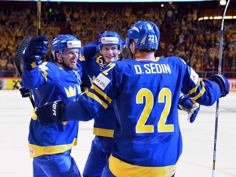 Sweden's forward Loui Eriksson, forward Henrik Sedin and forward Daniel Sedin celebrate after scoring a goal during the semi final match Finland vs Sweden of the IIHF International Ice Hockey World Championship at Globe Arena in Stockholm