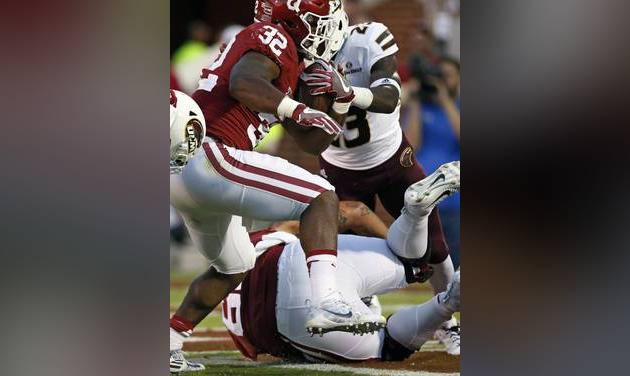 Oklahoma running back Samaje Perine carries past Louisiana Monroe cornerback Nick Ingram for a touchdown in the second quarter of an NCAA college football game in Norman Okla. Saturday Sept. 10 2016