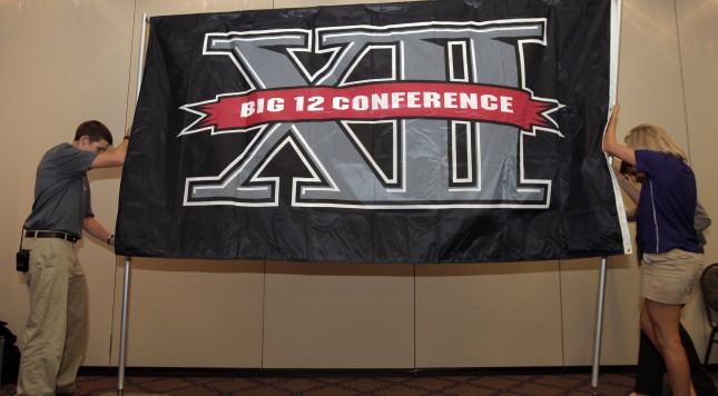 FORT WORTH TX- OCTOBER 10 Texas Christian University sophomore Zach Boring, and freshman Laura Dunn raise a Big XII Conference banner before a press conference in which TCU accepted an invention to join the Big XII