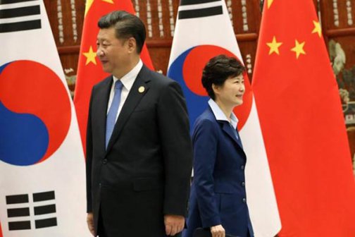 South Korean President Park Geun-hye walks past Chinese President Xi Jinping during their meeting on the sidelines of the G20 Summit