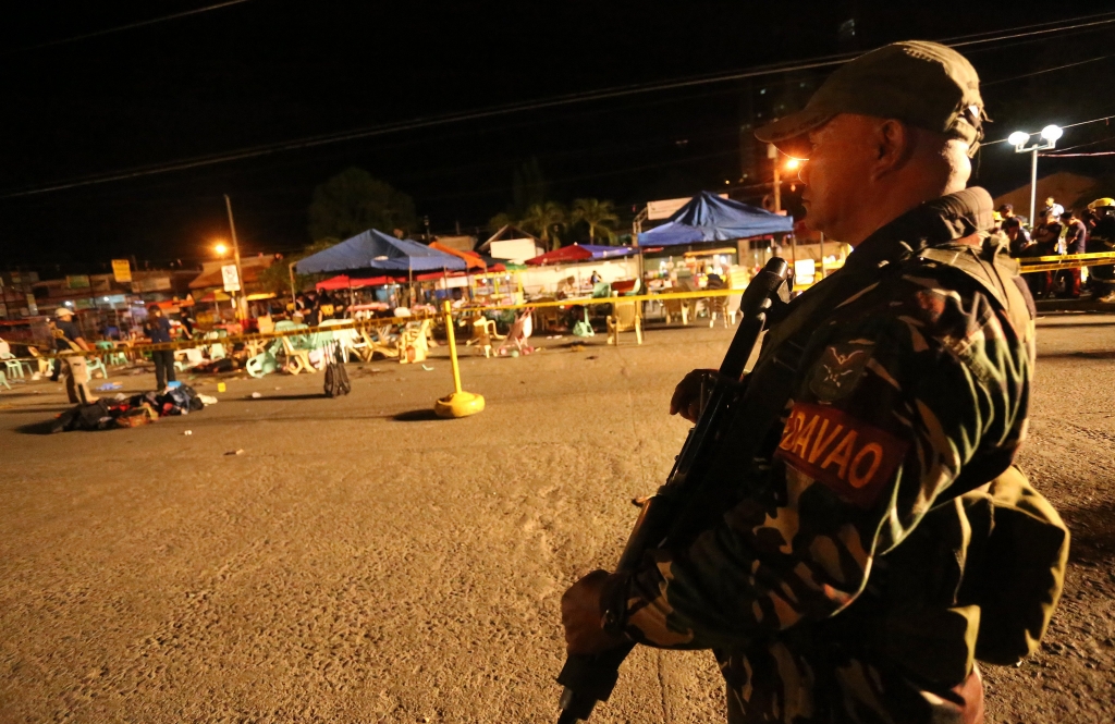 A Philippine soldier keeps watch at a blast site at a night market that has left several people dead and wounded others in southern Davao city Philippines late Friday Sept. 2 2016. The powerful explosion in Philippine President Rodrigo Duterte's hometow