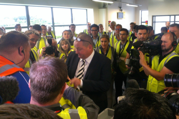 Mike Ashley undergoes a mock search at the Sports Direct warehouse