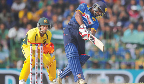 COLOMBO Sri Lanka’s Kusal Perera plays shot against Australia as Mathew Wade watches during their second one day international cricket match in Colombo Sri Lanka yesterday. — AP