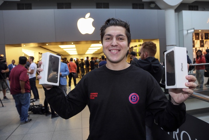 Reuben Kiblitsky holds two iPhone 7 he bought at the Eaton Centre Apple store