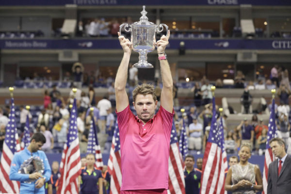 Stan Wawrinka of Switzerland holds up the championship trophy after beating Novak Djokovic of Serbia to win the men's singles final of the U.S. Open tennis tournament Sunday Sept. 11 2016 in New York