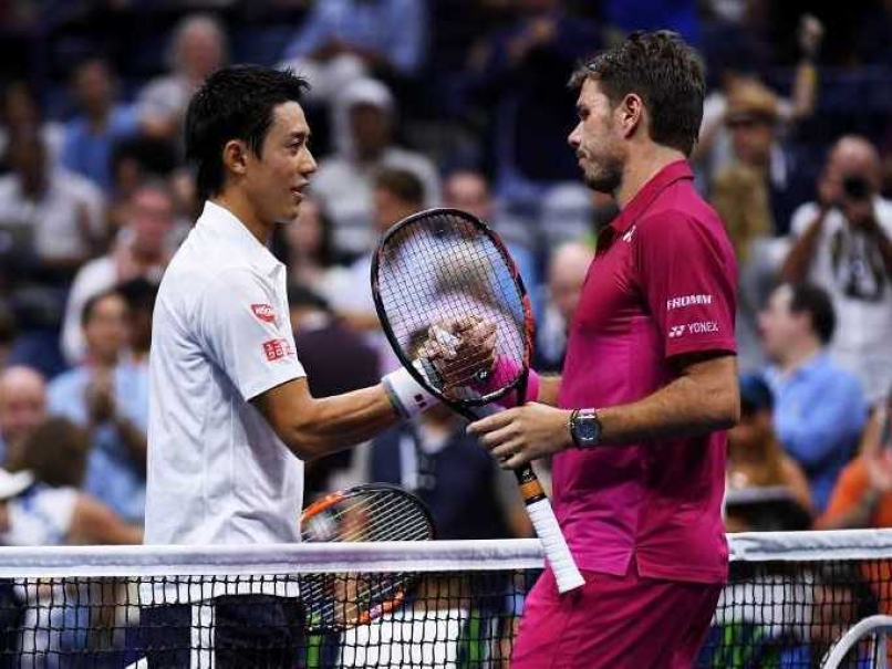 Stan Wawrinka of Switzerland shakes hands with Kei Nishikori of Japan after their semifinal