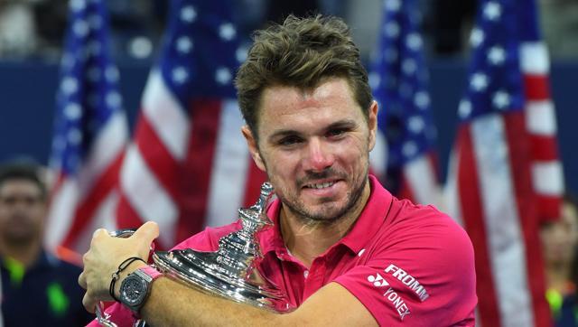 Stan Wawrinka of Switzerland celebrates with the championship trophy