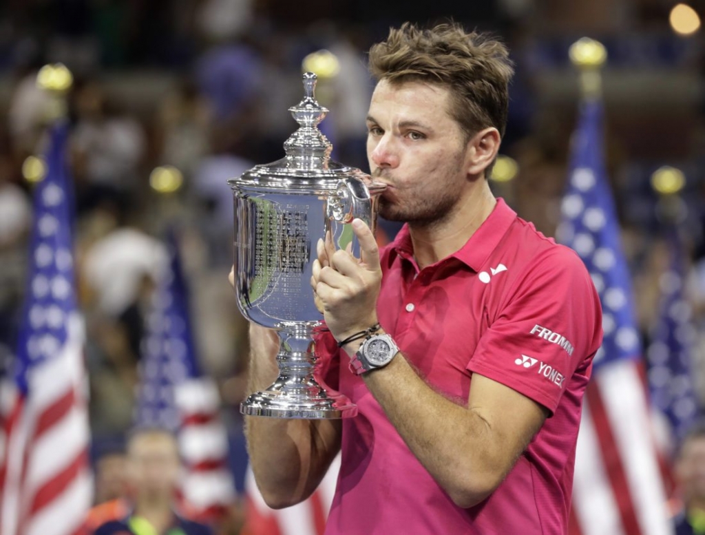 Stan Wawrinka of Switzerland holds up the championship trophy after beating Novak Djokovic of Serbia to win the men's singles final of the U.S. Open tennis tournament Sunday Sept. 11 2016 in New York