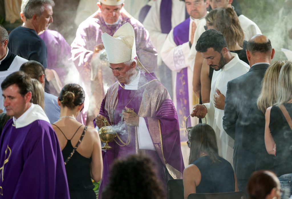 Giovanni D'Ercole bishop of Ascoli Piceno spreads incense during a funeral service for victims of the earthquake inside a gym Italy