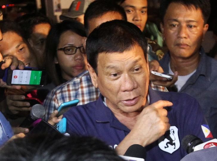 Philippines President Rodrigo Duterte is interviewed by reporters after visiting the explosion site at a market in Davao City Philippines