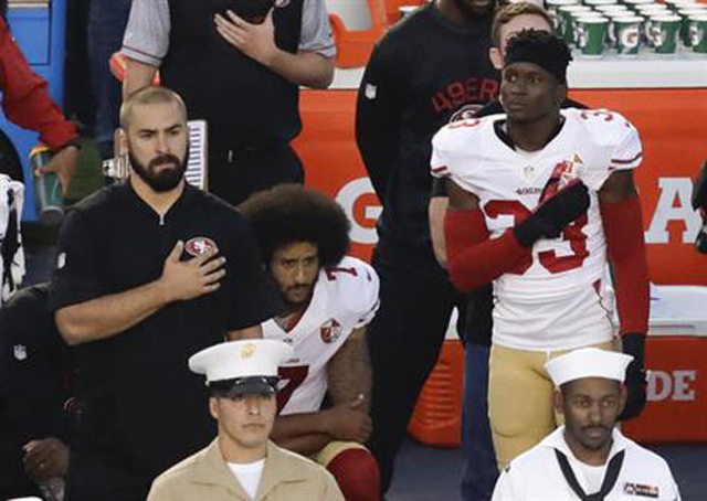 San Francisco 49ers quarterback Colin Kaepernick middle kneels during the national anthem before the team's NFL preseason football game against the San Diego Chargers Thursday Sept. 1 2016 in San Diego