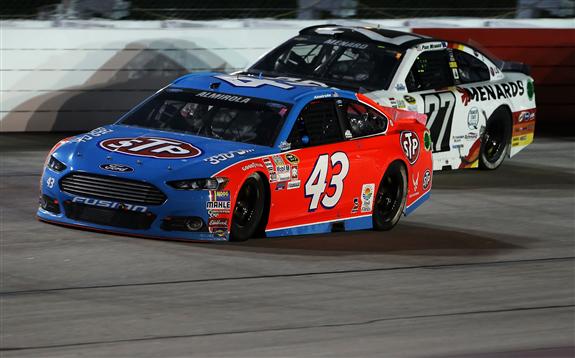 Aric Almirola races Paul Menard in their throwback schemes last year in the Bojangles&#039 Southern 500 at Darlington Raceway