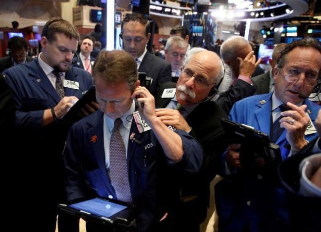 Traders work on the floor of the NYSE