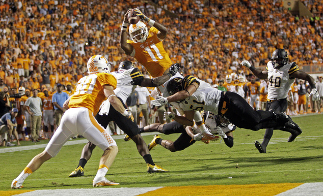 Tennessee quarterback Joshua Dobbs leaps for the end zone as he's hit by Appalachian State linebacker Kennan Gilchrist, defensive lineman Caleb Full