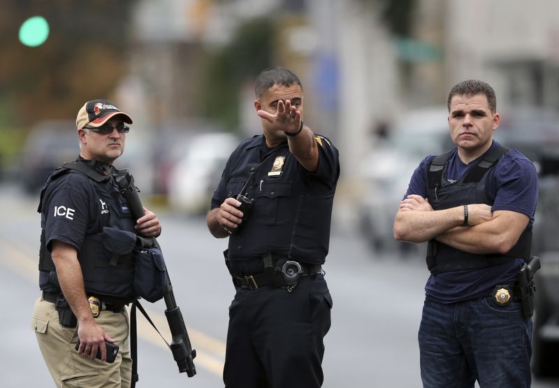 Police officers stand on Elizabeth Ave. in Linden N.J. near where a suspect in the bombings in Chelsea and New Jersey over the weekend was taken into custody after a shootout with the police