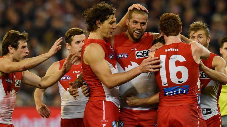 Sydney Swans teammates swamp Buddy Franklin after a goal against Geelong in the preliminary finalat the MCG