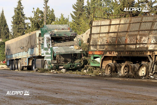 FILE- This Tuesday Sept. 20 2016 file image provided by the Syrian anti-government group Aleppo 24 news shows damaged trucks carrying aid in Aleppo Syria. A U.N. humanitarian aid convoy in Syria was hit by airstrikes Monday as the Syrian military