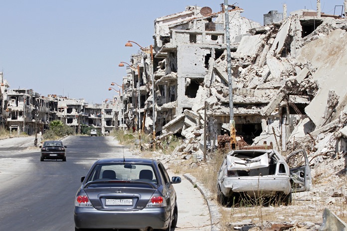 Damaged buildings and rubble line a street in Homs Syria Sept. 19 2016. Syria’s military command has declared the U.S-Russian brokered cease-fire over blaming the rebel groups for undermining