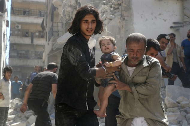 Syrian rescuers carry a little girl from the rubble following a reported airstrike on the rebel-held Salihin neighbourhood of Aleppo