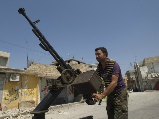 A Syrian rebel fighter loads an anti-aircraft machinegun in the northern town of Atareb 25 kms east of Syria's second largest city Aleppo