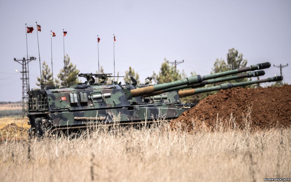 Turkish military tanks are seen during clashes between Turkish soldiers and Islamic State group fighters 20 km west of the Turkish Syrian border town of Karkamis in the southern region of Gaziantep