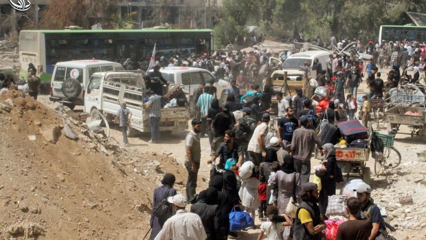 Syrians prepare to evacuate from Daraya a blockaded Damascus suburb on Friday in