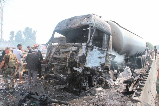 Syrian army soldiers inspect the damage at the site of two explosions that hit the Arzouna bridge area at the entrance to Tartous Syria