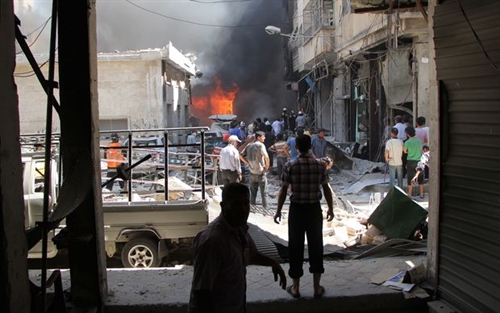 Syrian men search for victims at the scene of a reported air strike on the rebel-held northwestern city of Idlib. — AFP  VNA