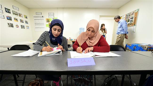 Syrian refugees take notes during their Vocational ESL class at the International Rescue Committee center in San Diego