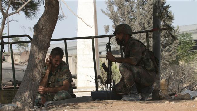 Syrian soldiers are seen at a position on the southern outskirts of the Syrian city of Aleppo